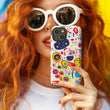 Women wearing white sunglasses holding the playful pizzazz tough phone case by Studio Bilby.